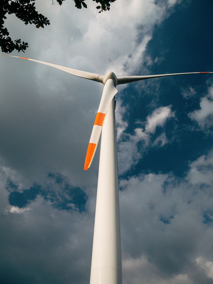 Mastering the First Impression: Your intriguing post title goes here Close-up of a wind turbine and clouds, symbolizing clean energy solutions.